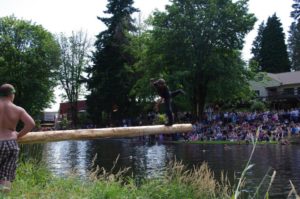 Man balancing on a log at the Jamboree