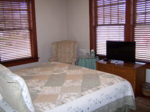 The Lewis and Clark room is our only downstairs room. Furnished with a king bed and private bath with a walk in shower. There is a desk with a chair and a wing back chair with a side table. It has a dresser too.